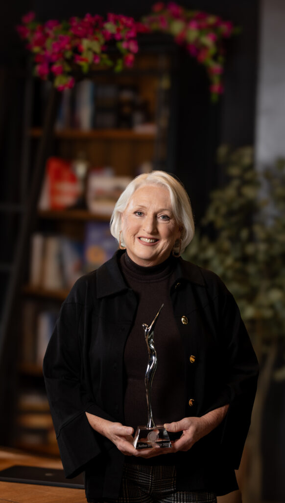 Debbie Widhalm holding an award